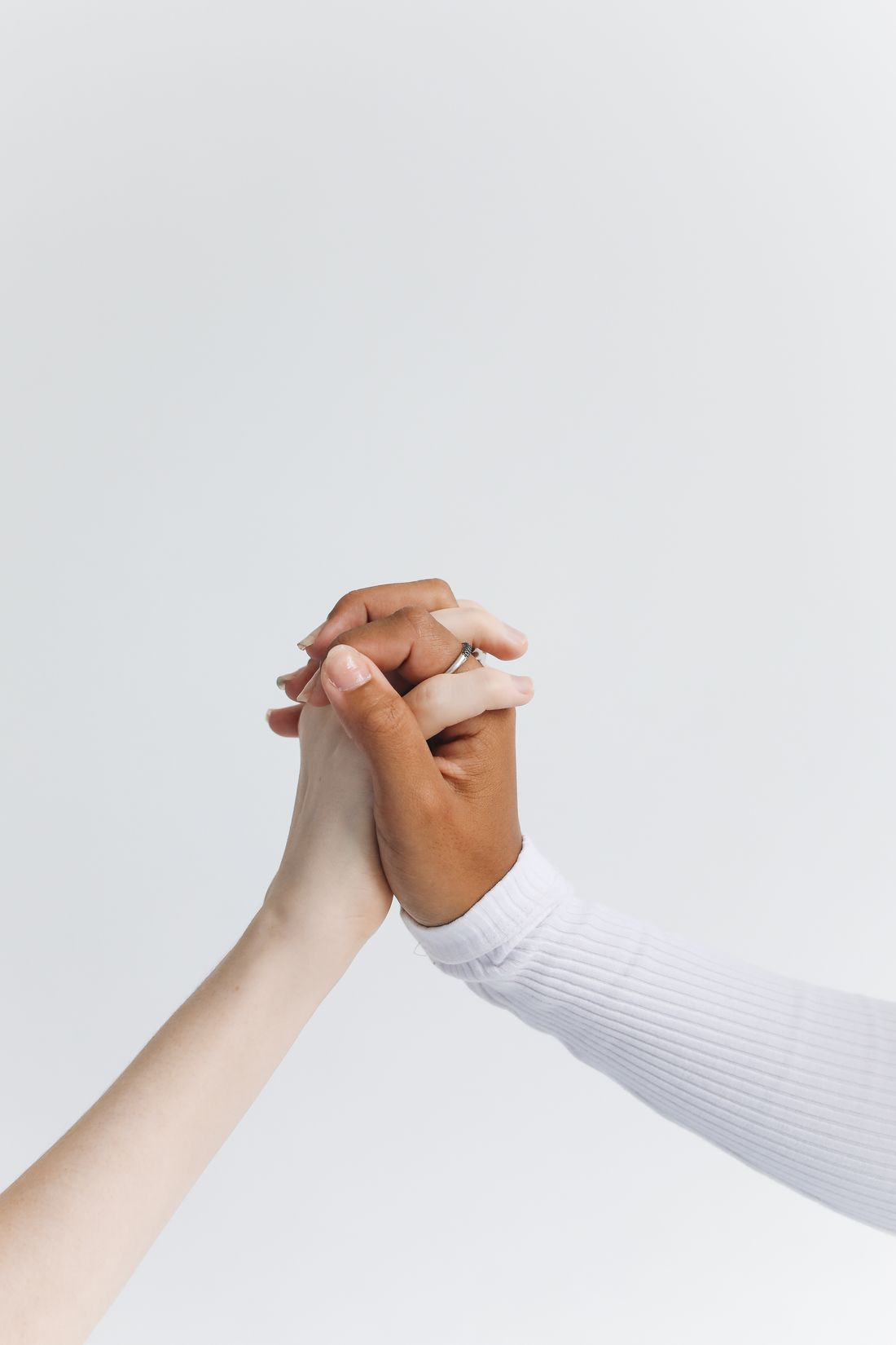 Two hands clasped together, a quiet duo