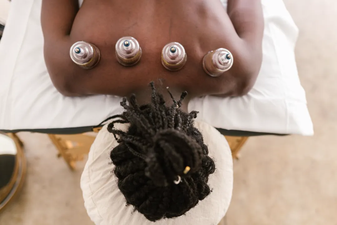 Dry cupping along the back during a continuous recovery massage